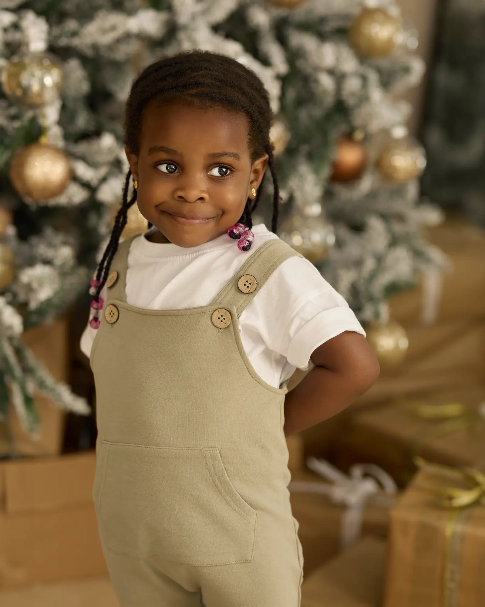 TUSO organic cotton baby overall with coconut shell buttons artichoke worn by a girl | Paalm Baby Clothing Nigeria