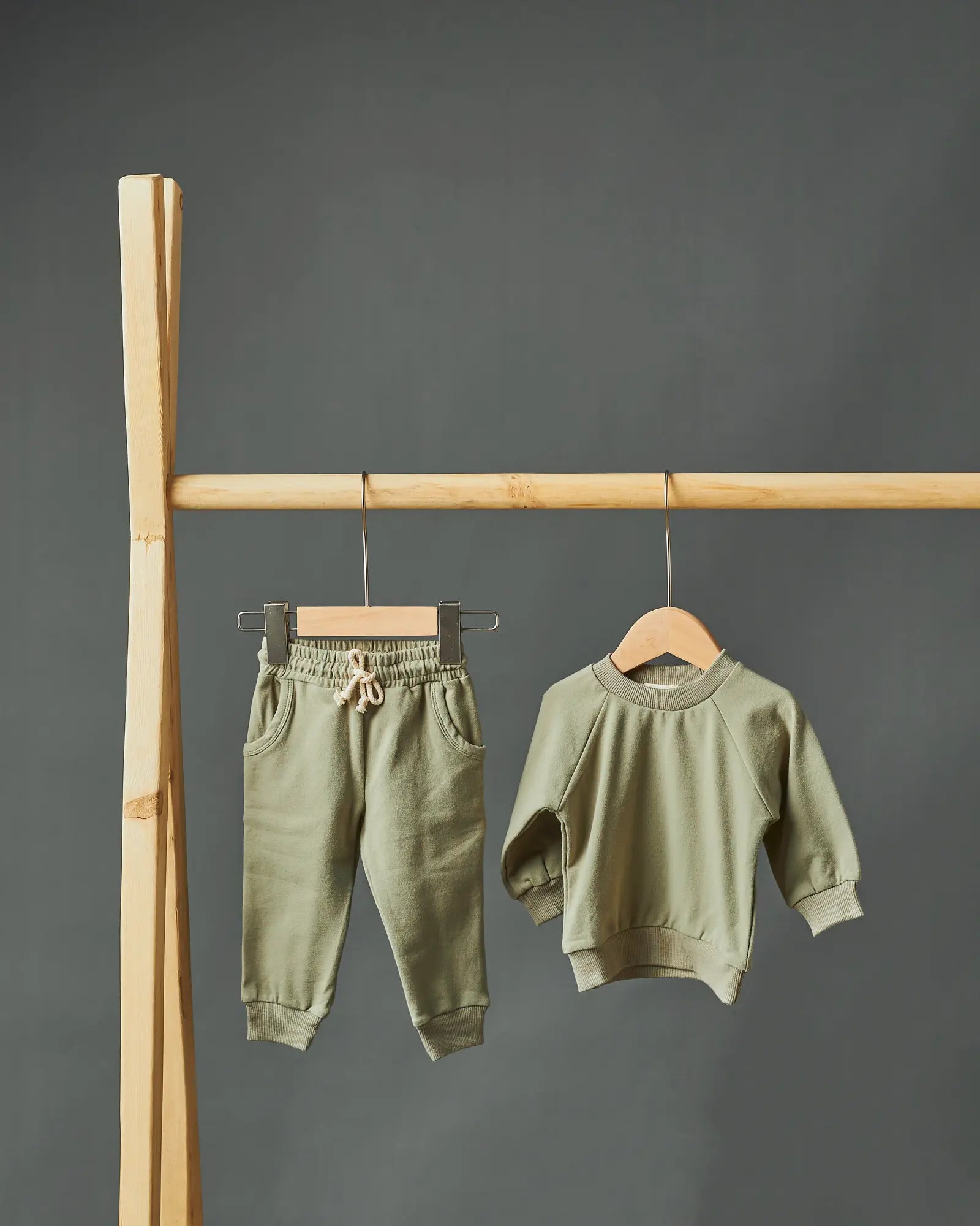ARYAN organic cotton baby sweat set joggers and top in artichoke hanging on a rack | Paalm Baby Clothing Nigeria