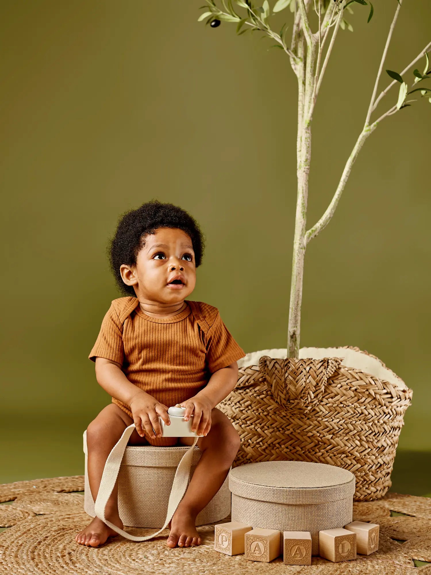 Ari organic ribbed baby bodysuit onesie - lead-free snaps cinnamon on sitting baby | Paalm Baby Clothing Nigeria